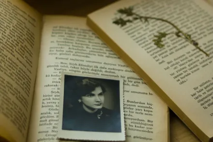 Open books with vintage photographs and dried flowers depicting nostalgic memories.