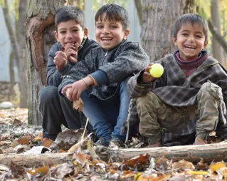 Joyful group of boys enjoying an autumn day in a forested area.