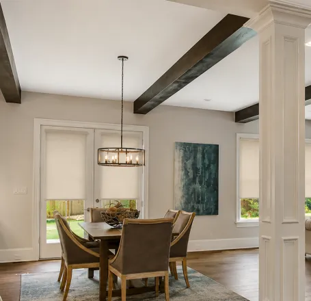 Modern kitchen interior with decorative vase on shelf of cabinet and window blind against table in house