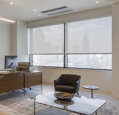 A modern room with large windows, cozy couches, and a beautiful water view.