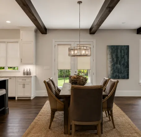 Bright and airy room with modern minimalist decor featuring wooden floors and ample natural light.