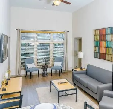 A modern room with large windows, cozy couches, and a beautiful water view.
