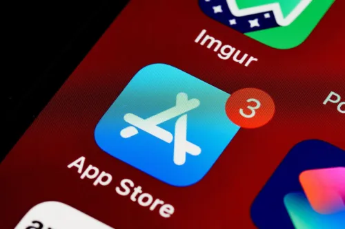 Close-up of App Store icon on iPhone screen with notification badge, highlighting app updates.