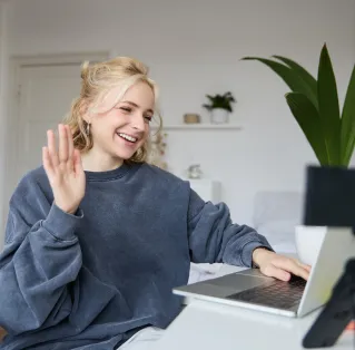 A person writes on a document using a clipboard indoors.