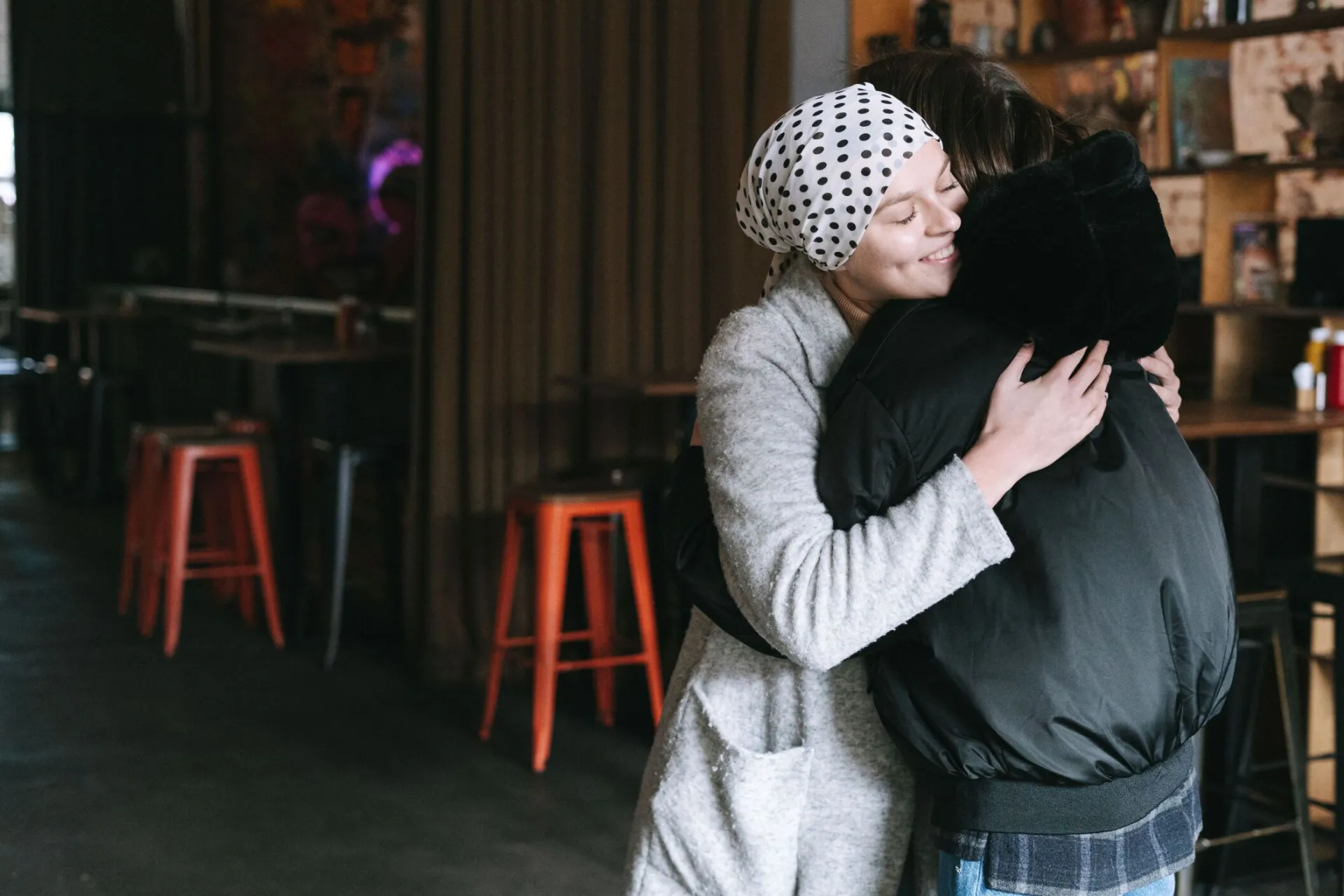 Two individuals sharing an embracing moment, symbolizing support and care.
