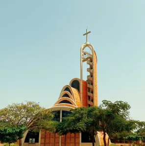 Modern Catholic church in Nianing, Sénégal with unique architecture and vibrant surroundings.