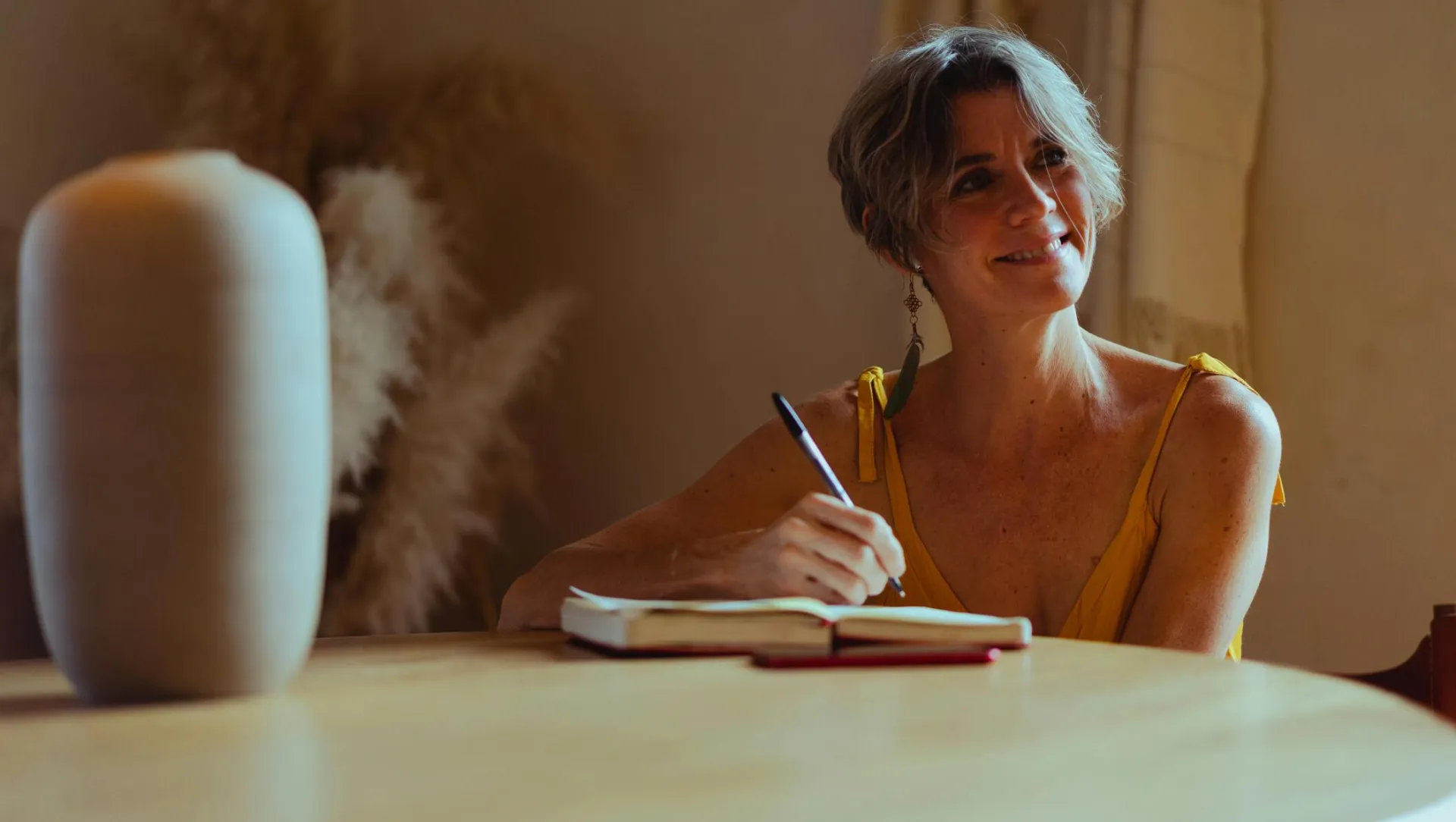 Elderly Woman Writing Her Diary while Smiling
