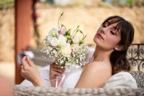 Bride enjoys a peaceful moment embracing a delicate bouquet in Porto Cervo, Sardinia.