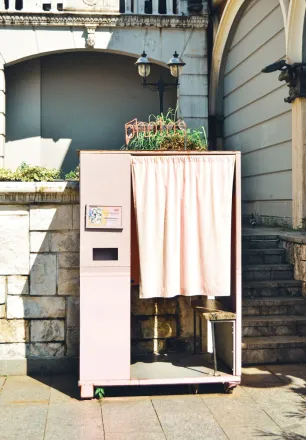 Vintage photo booth on a sunny Batumi sidewalk. Perfect for capturing retro vibes.