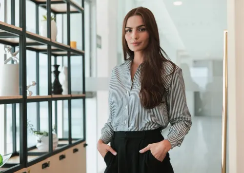 Portrait of a confident businesswoman standing in a modern office environment.