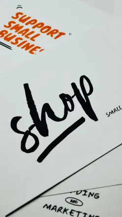 A close-up of a card with 'shop small' message promoting local small businesses.