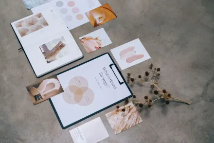 A modern flat lay of branding strategy documents and design elements on a desk.