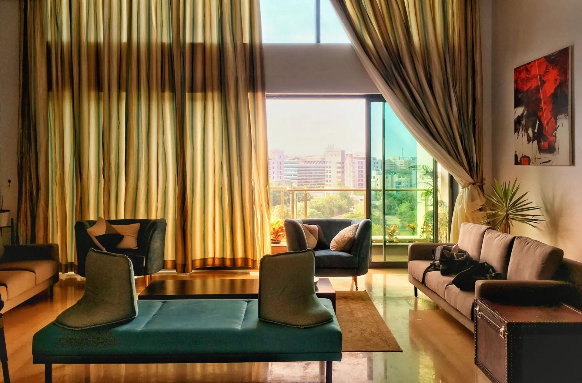 Spacious living room with large windows showcasing a city view in Bengaluru.