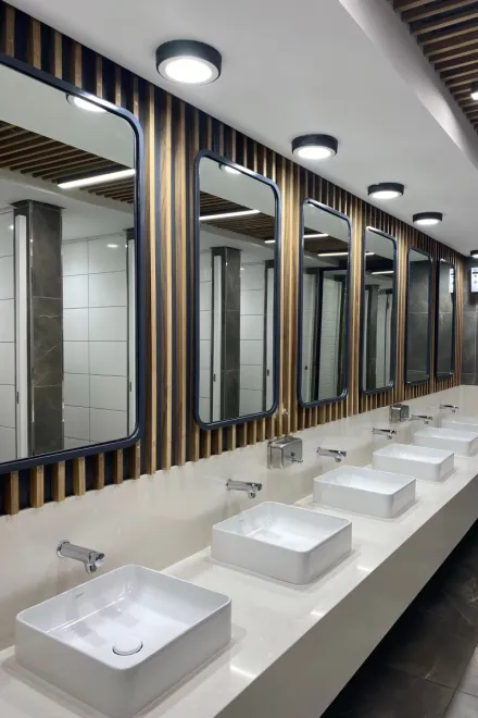 Contemporary and stylish restroom with sinks, mirrors, and lighting.