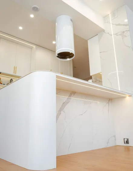 Sleek kitchen design featuring white marble countertops and modern fixtures.