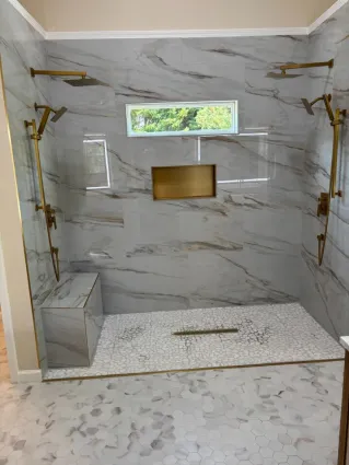 Elegant bathroom design featuring a shower cabin, vanity, and toilet.