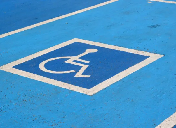 Close-up of a blue disabled parking spot with a wheelchair symbol.