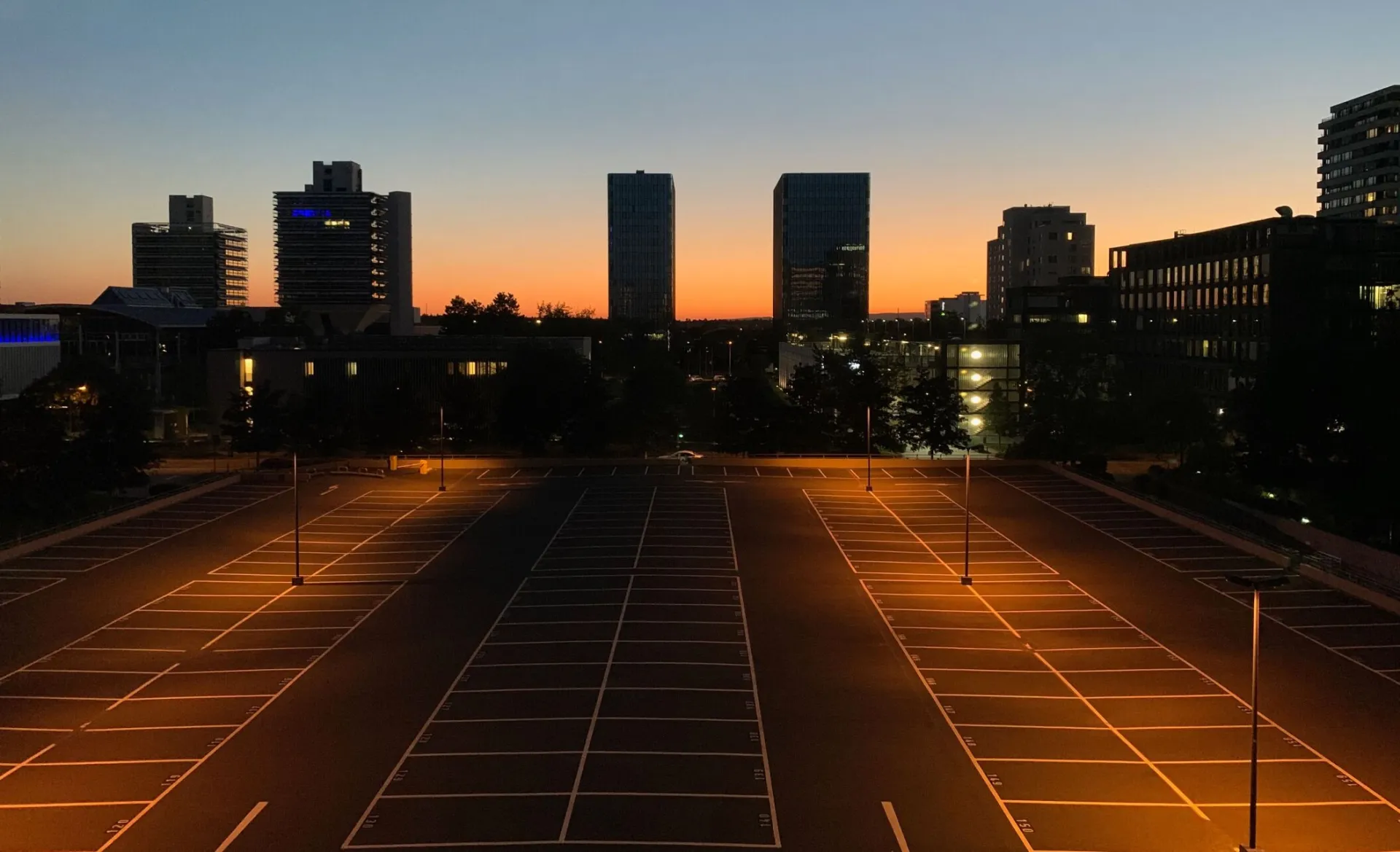 A stunning aerial view of Frankfurt's skyline and empty parking lot under the evening sky.
