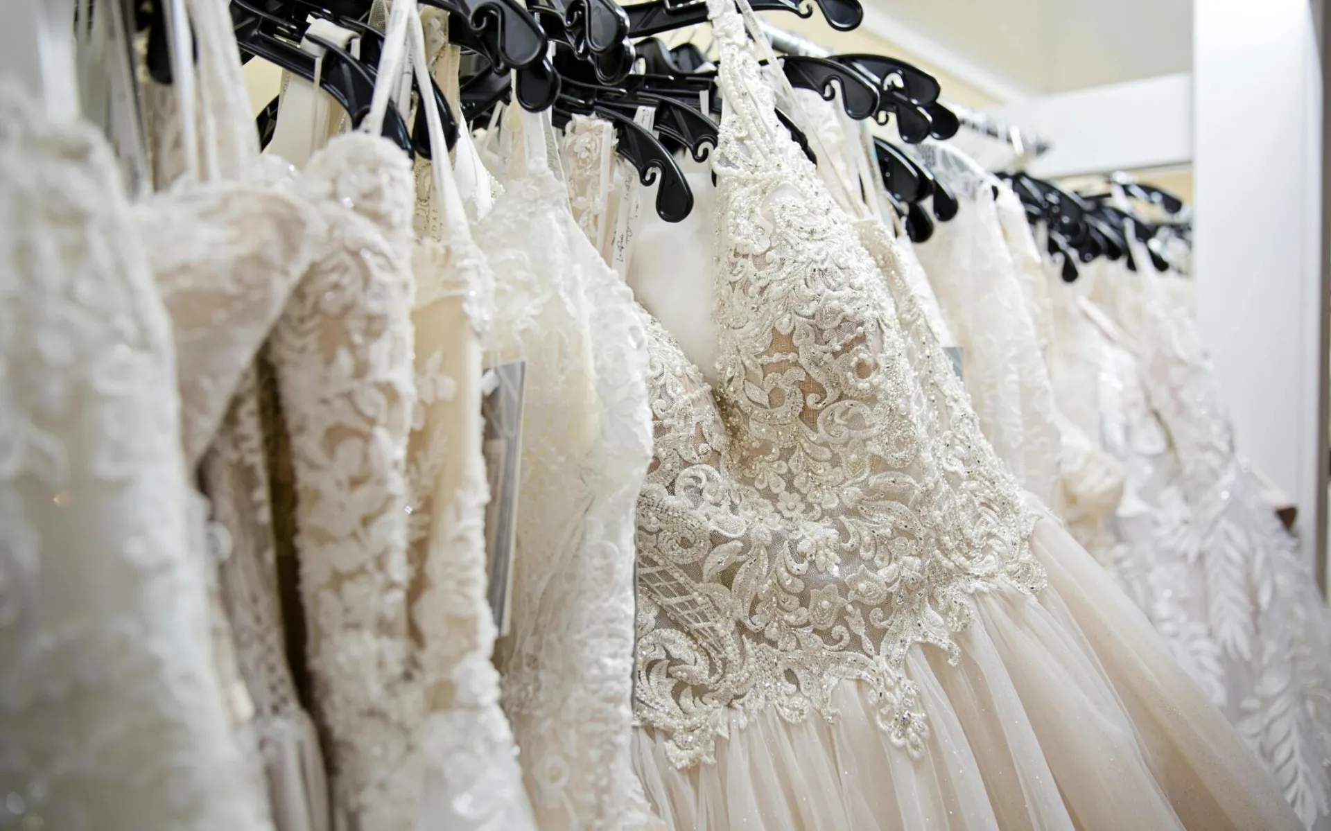 Beautiful lace wedding dresses on display in a bridal boutique, showcasing intricate designs and elegance.